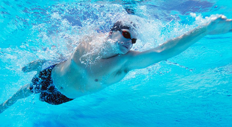 Underwater shot of professional male athlete swimming in pool